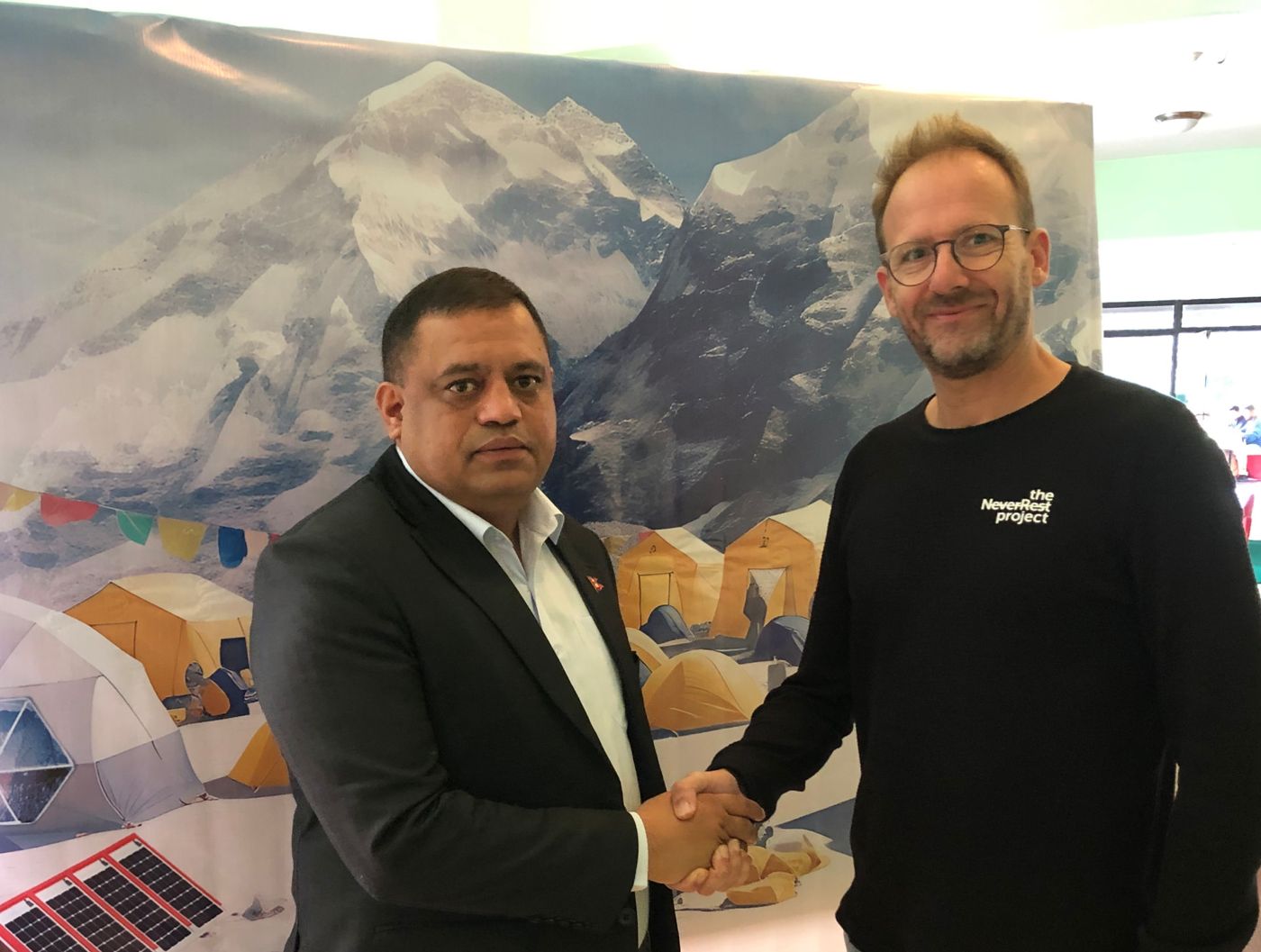Frédéric Kauffmann greeting a participant at a meeting in Nepal